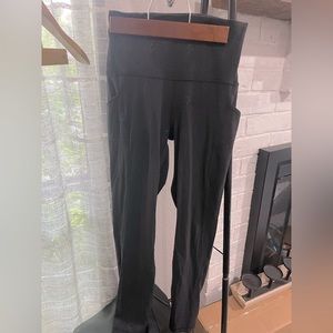 Lululemon black athletic wear leggings. All over lululemon emblem .
